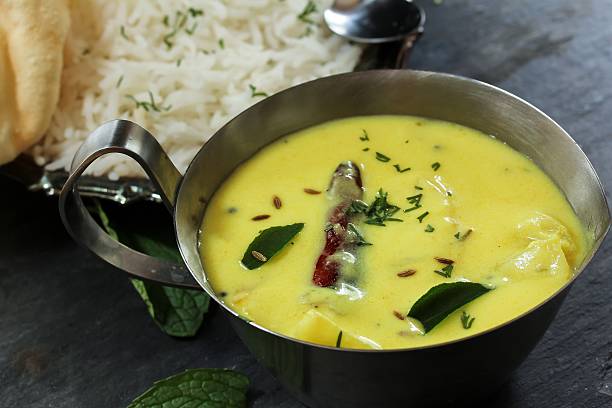 istock Gujarati Kadhi served with rice and papad, selective focus 609931730