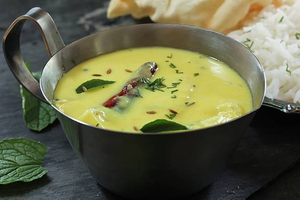 istock Gujarati Kadhi served with rice and papad, selective focus 609931772