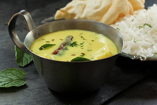 istock Gujarati Kadhi served with rice and papad, selective focus 609931806