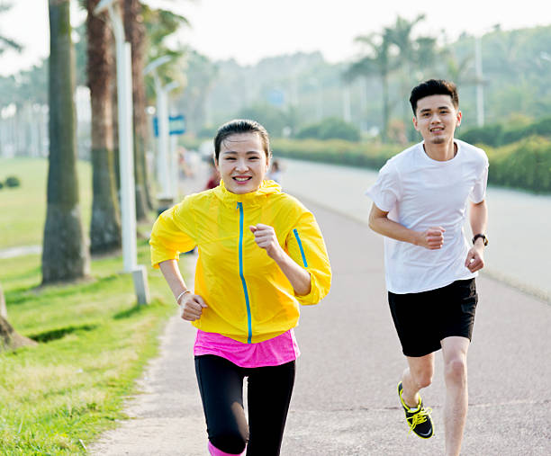 istock Young couple running together 609933350
