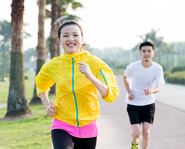 istock Young couple running together 609933484