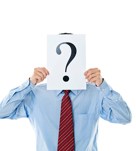 istock Confused businessman holding question mark 609933578