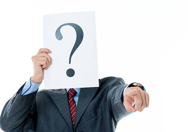 istock Confused businessman holding question mark 609934480