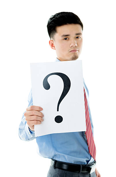 istock Confused businessman holding question mark 609934718