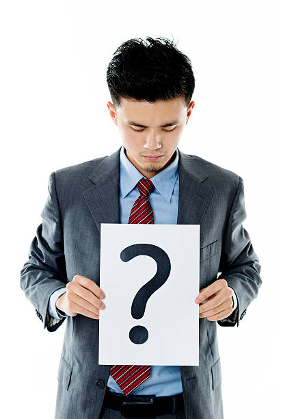 istock Confused businessman holding question mark 609935186