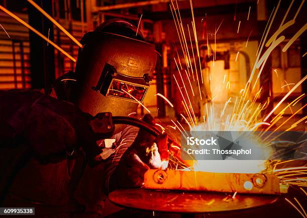 Worker Welding In Factory Stock Photo - Download Image Now - Welder, Welding, Manufacturing