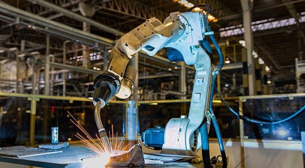 robot welding robot welding in car factory robot arm stock pictures, royalty-free photos & images