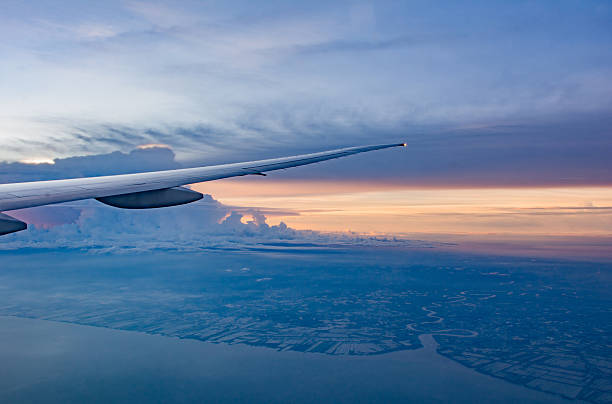 istock Look from window to Airplane  to sunset sky 609938096
