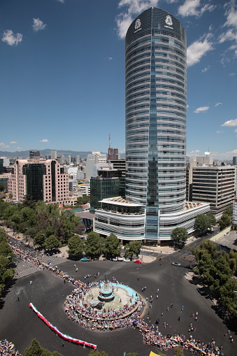 Mexico city, Mexico - April 25, 2010: Mexico city skyline with Bicentennial Parade and Street Performances at Diana the Huntress Fountain (Fuente De La Diana Cazadora), in Mexico city, Mexico.