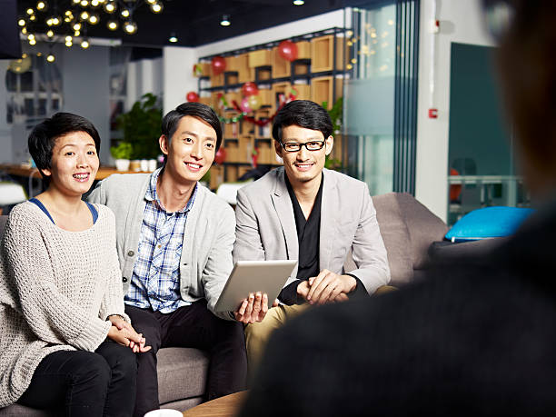 istock young business people talking to boss 609940996