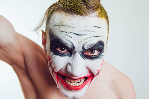 istock Man with Halloween face art on white background 609942574