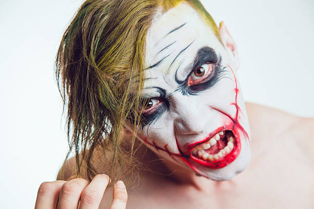 istock Man with Halloween face art on white background 609942944