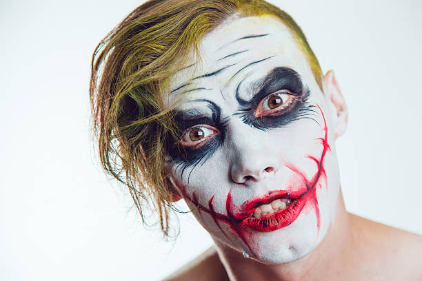istock Man with Halloween face art on white background 609943036