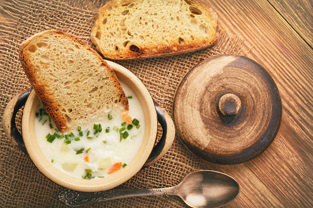 istock Cheese cream soup on brown wooden background . 609945754