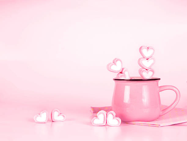 istock marshmallow heart shape in cup on pink background 609945994