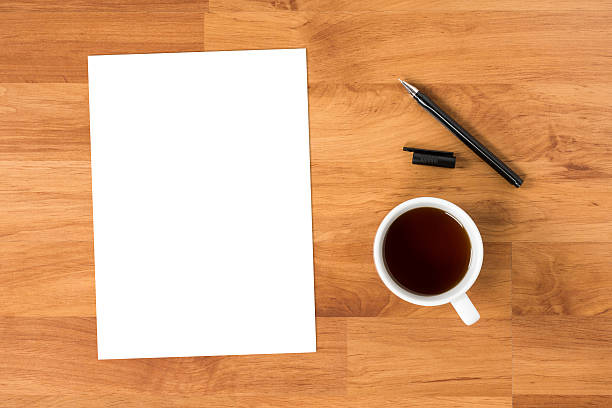 istock Blank paper is on top of wood table with pen. 609947088