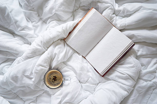 istock Cup of coffee and vintage notebook on bed 609947100