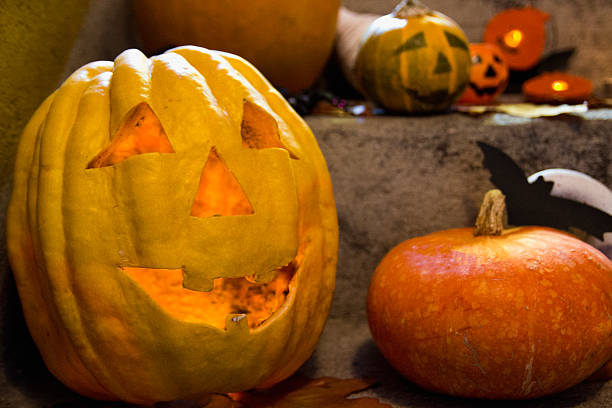 istock Halloween pumpkin head jack lantern on wooden background 609947106