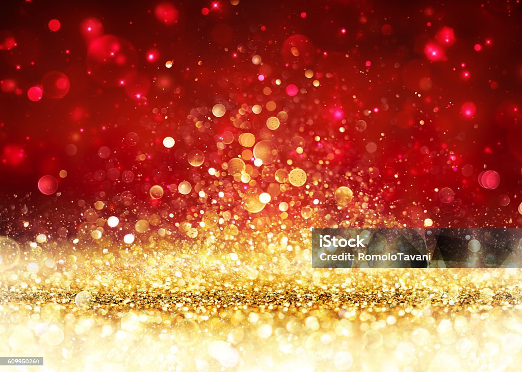 Christmas Background - Golden Glitter On Shiny Red Backdrop For Presentation and Showing Of Christmas Backgrounds Stock Photo