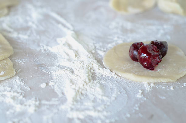 istock Cooking dumplings with cherries. Pierogi with Cherry. 609952224