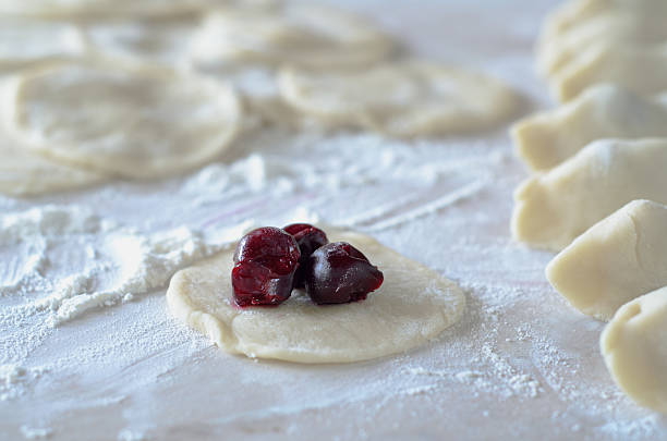 istock Cooking dumplings with cherries. Pierogi with Cherry. 609952268