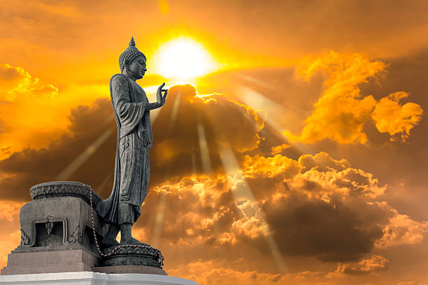 istock Buddha statue against on Golden sky with sunlight in background. 609952548
