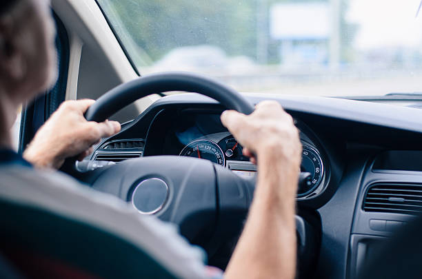 istock Driving a car, view from the back seat. 609952658