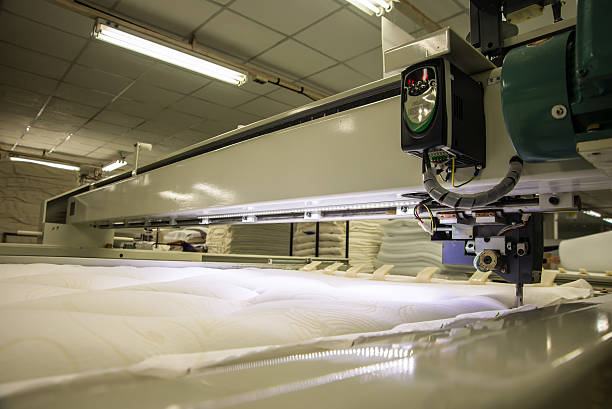 istock Industrial big embroidery machine on textile 609952746