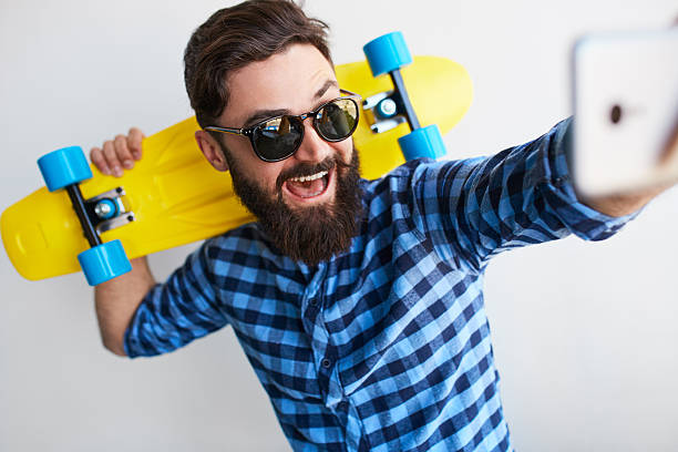 istock bearded hipster taking selfie with smartphone 609952894