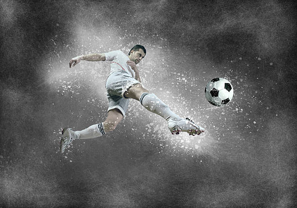 istock Football player with ball in action under sky with clouds 609953112