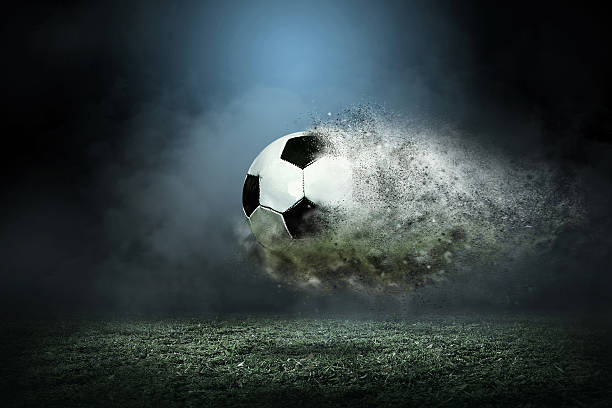 istock Moving soccer ball around splash drops on the stadium field. 609953118
