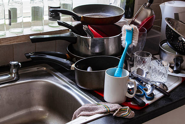 istock Washing up chores, housework, dirty pots on kitchen sink. 609953694