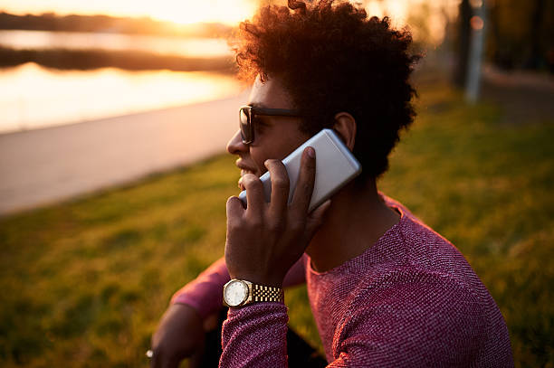 istock Young black man smiling and talking on smart phone 609954828