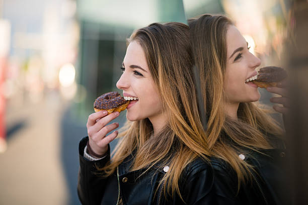 istock Sweet moments - eating donut 609955226
