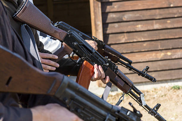 istock group of men makes theirs guns ready to fire 609955870