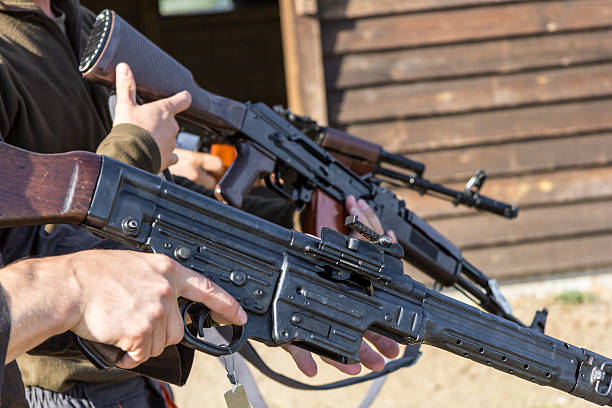istock group of men makes theirs guns ready to fire 609955908