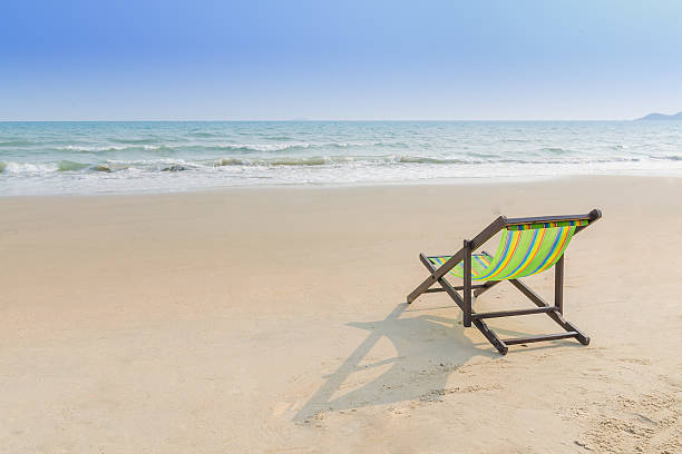 istock Beach chair on the sand ( feel lonely concept) 609956134