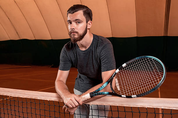 istock young sportsman playing tennis 609957346