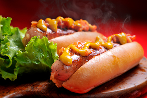 Delicious gourmet hot dog with fries and avocado