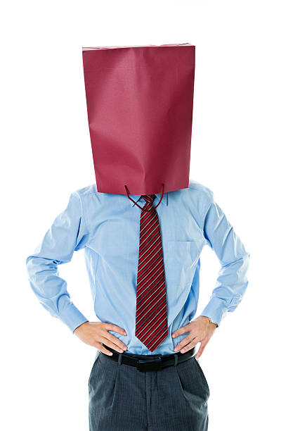 Businessman in paper bag mask against white background Businessman in paper bag mask against white background. anonymous businessman with paper bag on his head stock pictures, royalty-free photos & images
