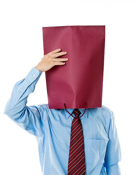 Businessman in paper bag mask against white background Businessman in paper bag mask against white background. anonymous businessman with paper bag on his head stock pictures, royalty-free photos & images