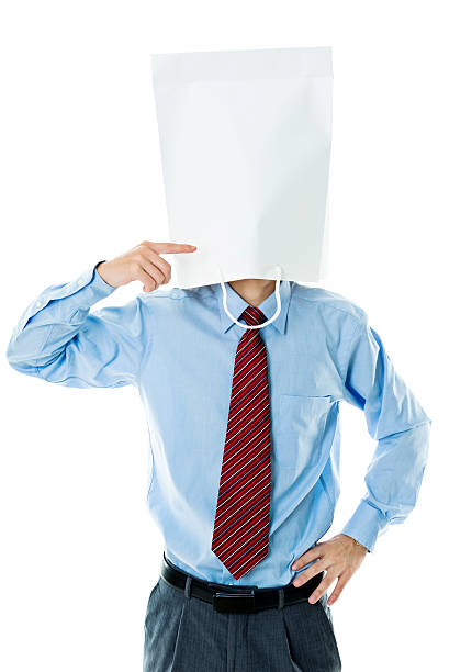 Businessman in paper bag mask against white background Businessman in paper bag mask against white background. anonymous businessman with paper bag on his head stock pictures, royalty-free photos & images
