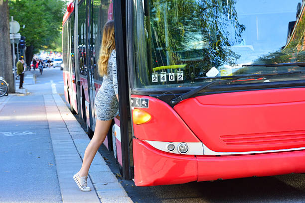 istock Young woman enters bus 610009962