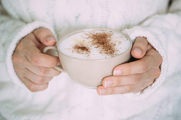 istock Female hands with hot drink or cappuccino, on color background 610010022