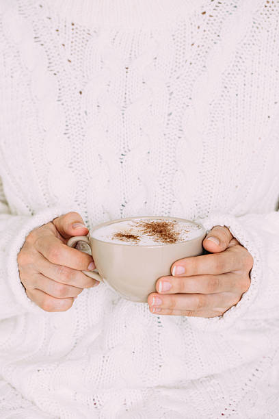 istock Female hands with hot drink or cappuccino, on color background 610010032