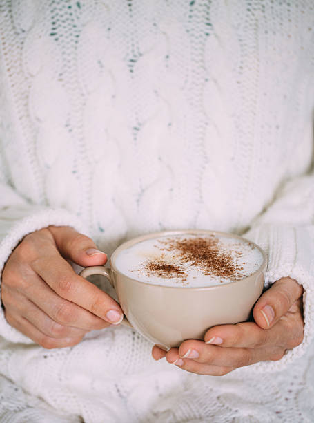 istock Female hands with hot drink or cappuccino, on color background 610010046