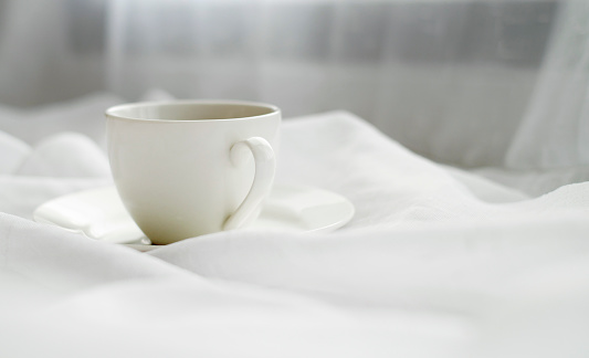 Cup on white fabric background