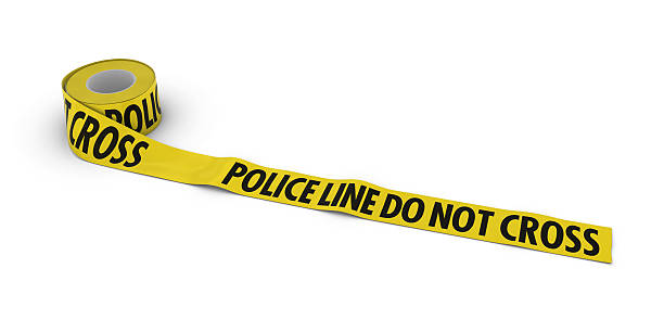 istock Police Line Do Not Cross Tape Roll unrolled across white 610015414