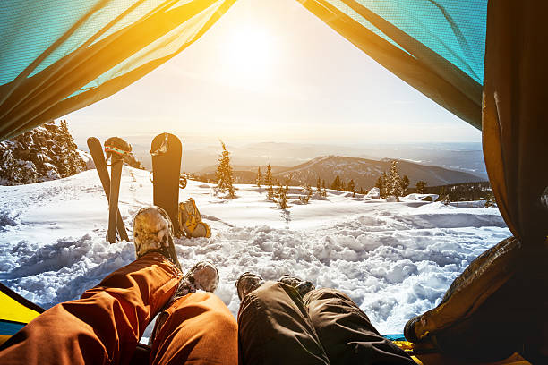 istock Snowboarders posing on blue sky backdrop in mountains 610015490