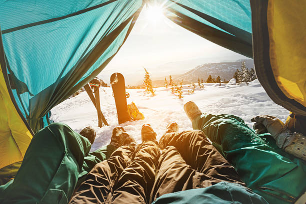 istock Snowboarders posing on blue sky backdrop in mountains 610015602